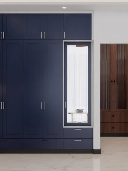 This bedroom project features a beautiful blue and white theme. The deep blue wardrobe includes an integrated dresser with a mirror, maximizing both storage and functionality in a stylish way.