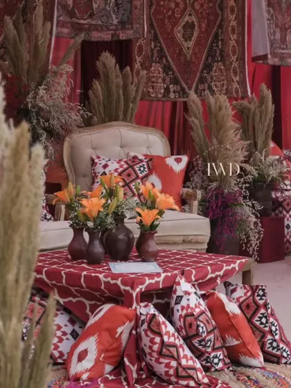 A cozy corner in our Moroccan-themed Mehendi, with floor seating, pampas grass, and rich, earthy tones. It's all about creating comfortable and stylish spaces for guests to relax.