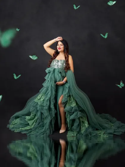 A creative edit with a water reflection and whimsical green butterflies, adding a magical touch to this portrait.