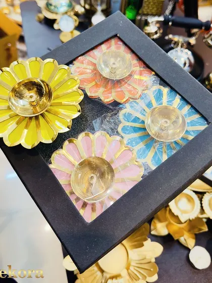 Another view of our popular metal brass diya gift set. The bright enamel colors on the flower-shaped holders make this a memorable and decorative Diwali gift.