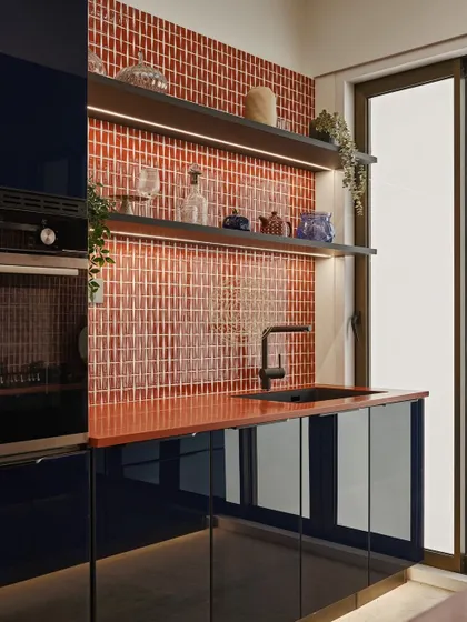 For the kitchen, we chose a playful and lively combination of dark blue cabinetry and a vibrant orange-red subway tile backsplash. It’s a functional space that doesn’t compromise on personality.