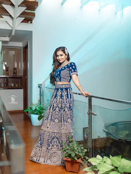 The rich velvet fabric and detailed embroidery of this blue lehenga create a luxurious feel, ensuring you look and feel your best on your special day.