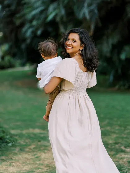 A mother walking away with her son, both looking happy and free. A beautiful candid moment.