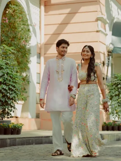 A candid shot of the couple walking and talking, capturing a natural and unposed moment.