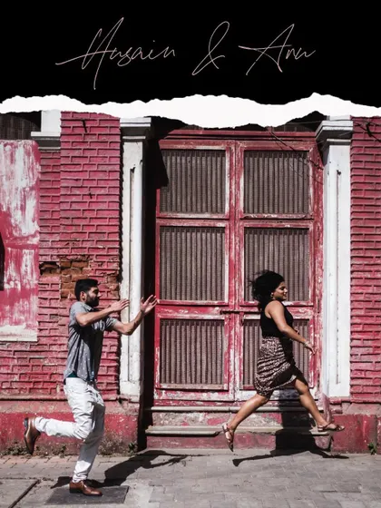 A playful chase in front of a rustic red door. This action shot perfectly captures the fun and energetic dynamic of Husain and Ana.