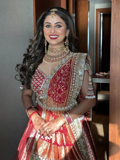 The full picture of bridal radiance. Her smile says it all. This classic bridal look with a red lip and defined eyes was designed to be timeless and elegant.
