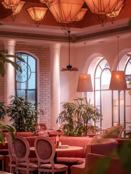 Another perspective of the main dining hall, showcasing the blend of textures from brick walls to soft upholstery. This versatile space can be configured for both large parties and more structured seated dinners.