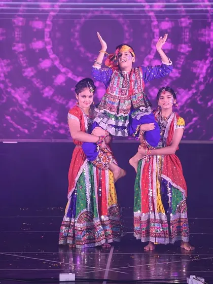 An impressive lift during the folk dance performance, showcasing the strength and coordination of our students.