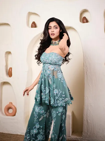 A different angle of Geethika's stunning teal set, showing off the intricate floral embroidery and the flattering strapless neckline.