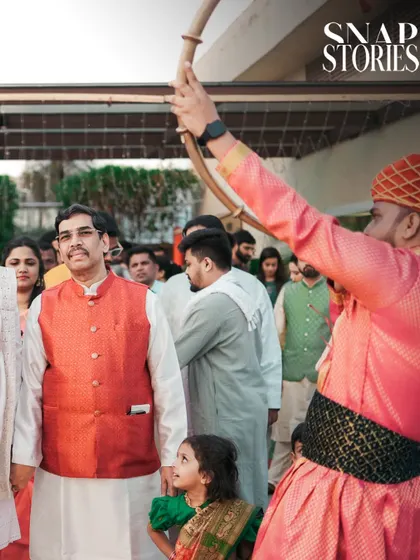 A candid moment during the groom's procession, capturing the expressions of family members. We believe in documenting the reactions of loved ones to tell a fuller story.