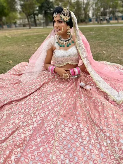 A beautiful pink banarasi lehenga, perfect for a day wedding or as a guest. The fabric has a lovely sheen and the jewellery completes the look.
