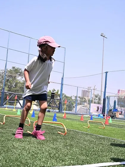 Two girls race through a hurdle course, demonstrating their agility and determination.