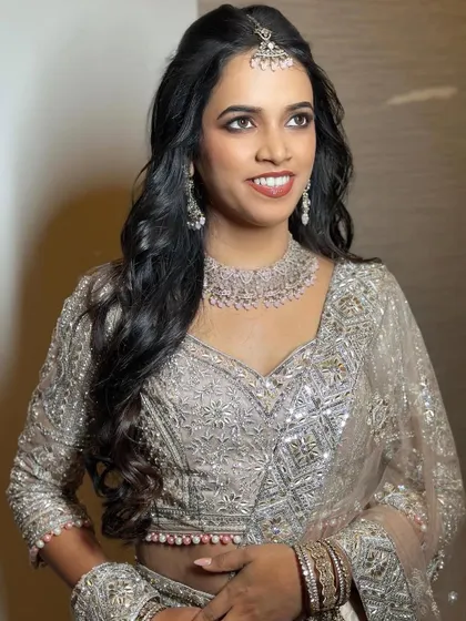 A side profile of the engagement look, showcasing the soft curls and the elegant, understated makeup.