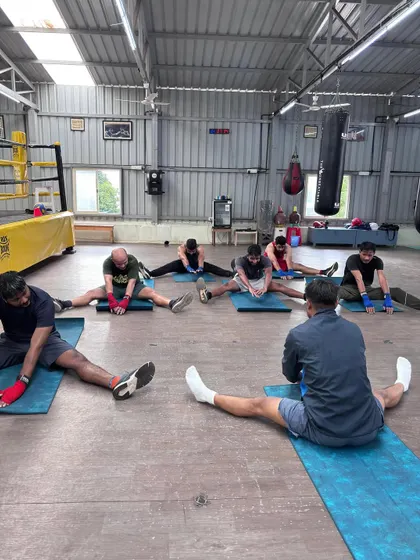 We work on flexibility after every class. This seated forward bend helps to stretch the hamstrings and lower back, areas that get tight from the explosive movements in boxing.