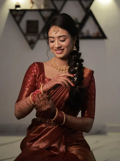 A candid moment showing off Shruthi's complete engagement look. The soft makeup and simple hairstyle create an aura of effortless grace and elegance.