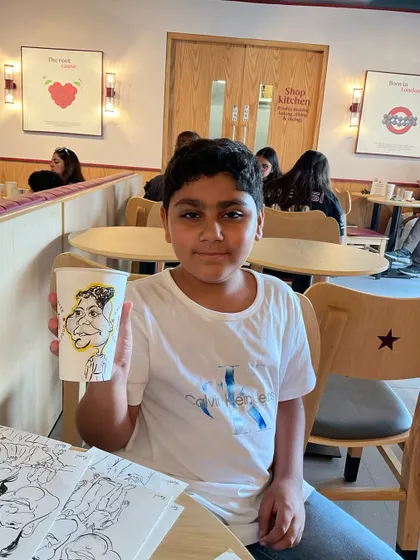 Another young fan of caricatures at the Pret A Manger launch event.