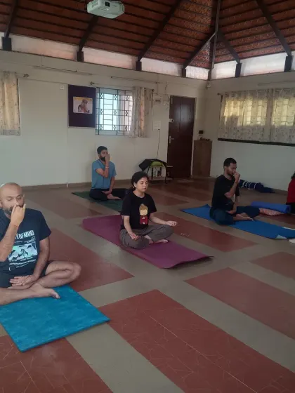 Participants practicing Nadi Shuddhi pranayama during a session. This breathing technique helps to balance the system and calm the mind. It is an essential part of our practice to prepare the inner environment for deeper states of meditation.