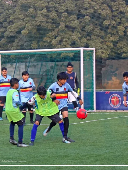 The game is on. Two players battle for the ball during a practice match, demonstrating the intensity and focus I expect from my teams during every game.