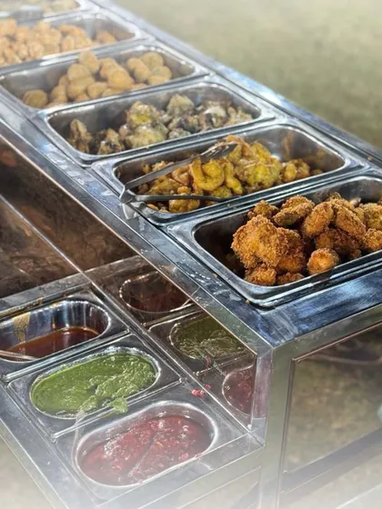 Our starter stations feature an impressive variety of appetizers. This display includes multiple trays of hot and cold starters with an assortment of flavourful chutneys and dips.
