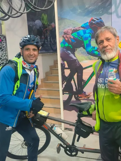Two riders at the finish, proud and exhausted. The bond forged over 600km on a tandem bike is unbreakable.