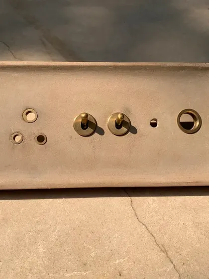 The stone version of the custom switch plate. The more rustic, earthy quality of the stone gives the same design a completely different character, tailored to its specific location within the house.
