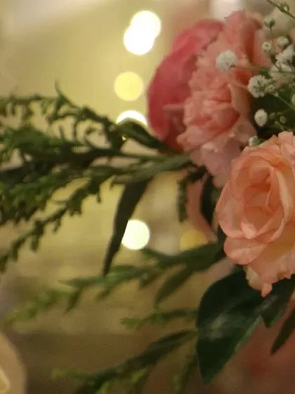 Another beautiful close-up of our floral work, showing the texture of carnations and roses against a softly lit background. We believe fresh flowers are essential for an elegant event.