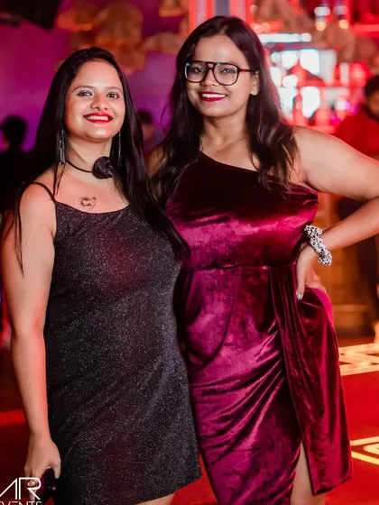 Two friends in velvet and sequins, dressed perfectly for a night of dancing.