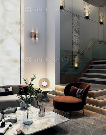 The entrance lobby of a home in Pitampura, featuring a grand staircase with step-lighting and a beautiful backlit onyx marble wall.