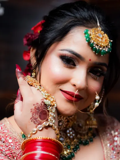 A close-up that highlights the intricate details of the henna and the hand jewelry.