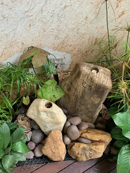 This fountain uses a combination of natural stones and pebbles to create a dry-creek-bed look around the main feature.