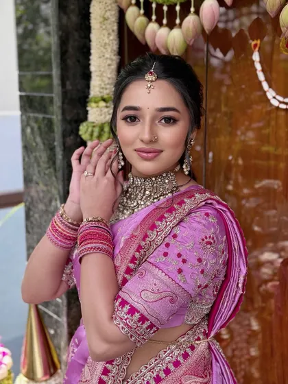 A happy and confident bride. The makeup is minimal yet majestic, with a focus on glowing skin and a soft pink lip.