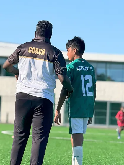 A coach provides guidance to one of our U-13 players during a match in London. This international exposure is invaluable for their development and confidence.