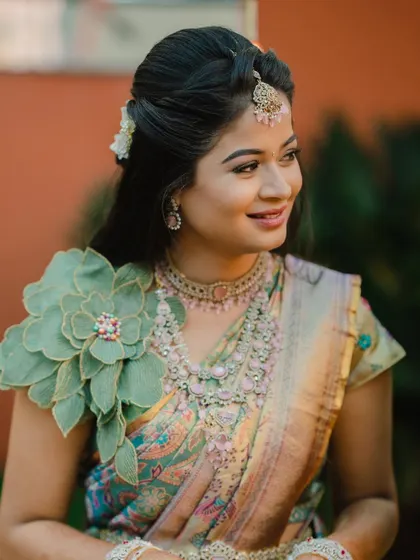 A portrait of the bride, her unique blouse with a large floral shoulder piece making a fashion statement.