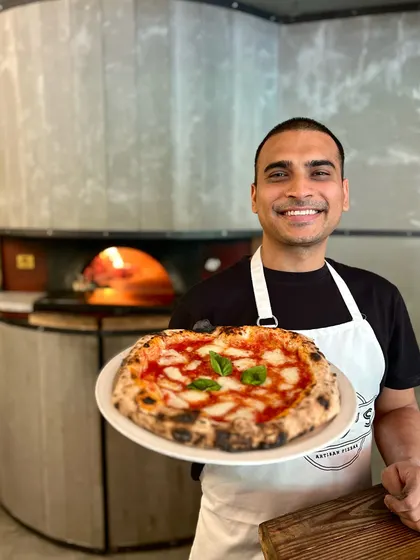 The classics never get old. Our head pizzaiolo with a perfect Margherita.