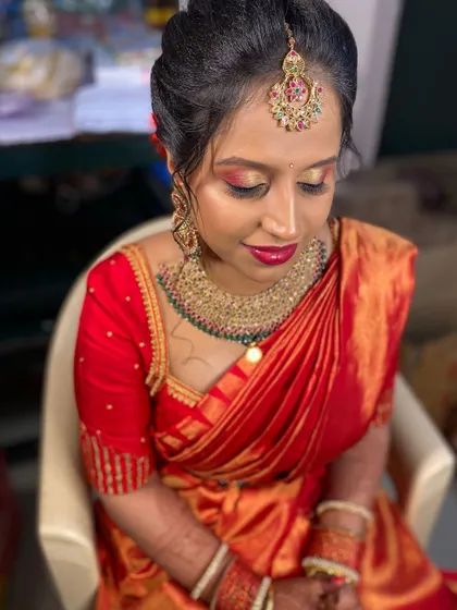 A close up of Sowmya's beautiful bridal makeup. The warm, shimmery eyeshadow and bold lip colour are perfect for her red saree.