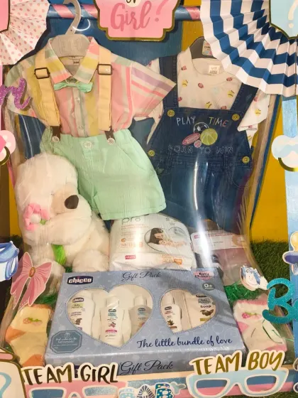The same baby shower hamper with 'Team Girl' and 'Team Boy' signs, making it a perfect centerpiece for a gender reveal party.
