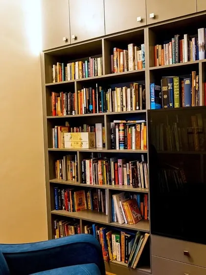 A floor-to-ceiling library and storage unit in the Murlis' home, providing ample space for books and display items while maintaining a sleek, contemporary look.