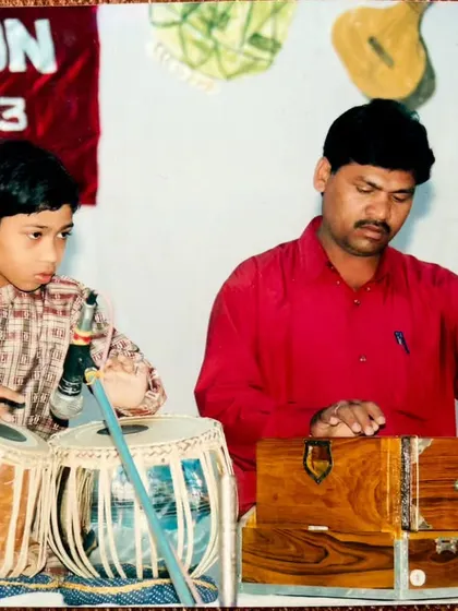 A childhood photograph with my father, who was my first teacher. He put me on the path of tabla, and I am forever grateful for his early guidance.