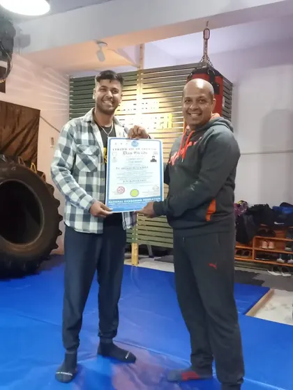 Another shot of Coach Sandeep receiving his 1st Dan Black Belt certificate.