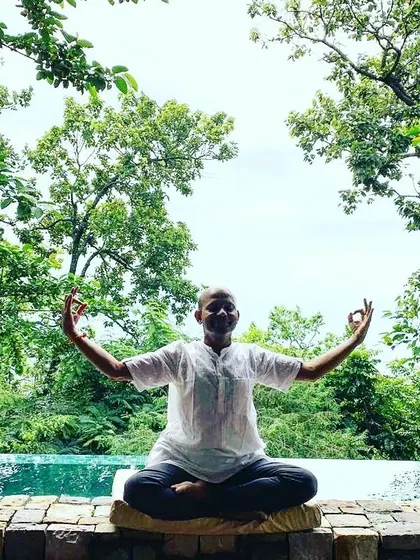 In this seated meditation pose, I open my arms with my fingers in Jnana Mudra. This gesture symbolizes wisdom and the connection of the individual self with the universal consciousness. It is a simple way to channel energy and focus during your practice.