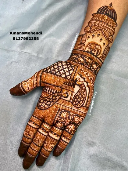 A majestic design featuring a grand palace dome on the wrist. The palm is adorned with a beautiful peacock and an elephant, classic symbols of royalty and grace in bridal mehndi.