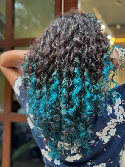 The vibrant turquoise tips from a different angle, showing how the color is woven through the ends.