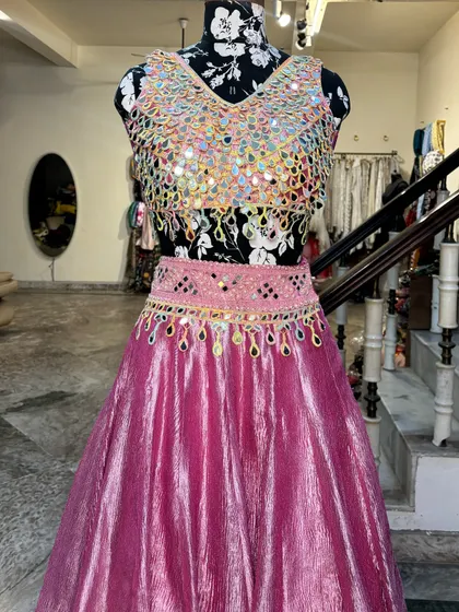 The detailed belt adds a modern touch to the lehenga and helps define the waist.