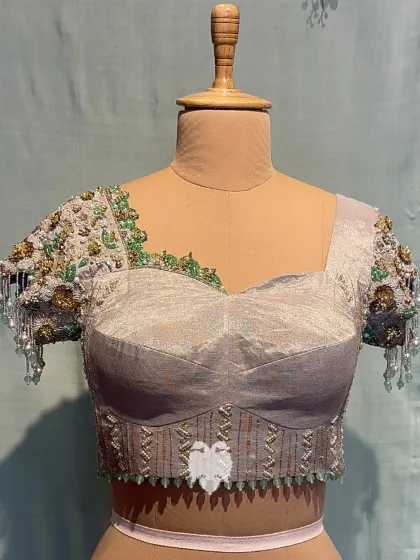 A full front view of Nithya's blouse, balancing structure and embellishment.
