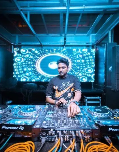 In the zone at Kitty Ko, surrounded by the signature blue lighting. My focus is always on the music and the energy of the people in front of me.