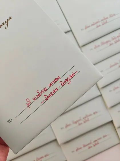 There is a special peace that comes from writing in my mother tongue. This is a close-up of envelope addressing in Gujarati, a service that feels like coming home and adds a deeply personal, traditional touch to your invitations.