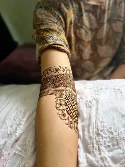 Another detail shot of a bridal armband, this time showing a combination of floral and geometric net patterns.