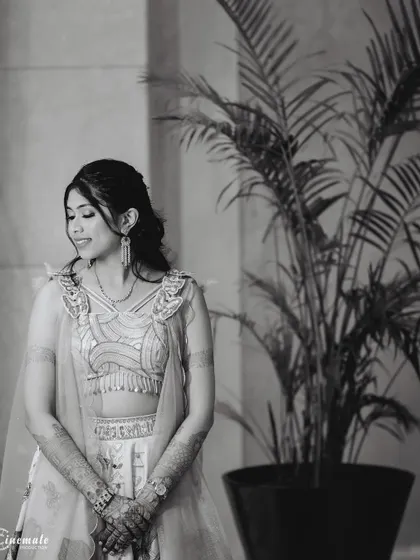 A candid black and white shot of the bride, capturing a natural, gentle smile.