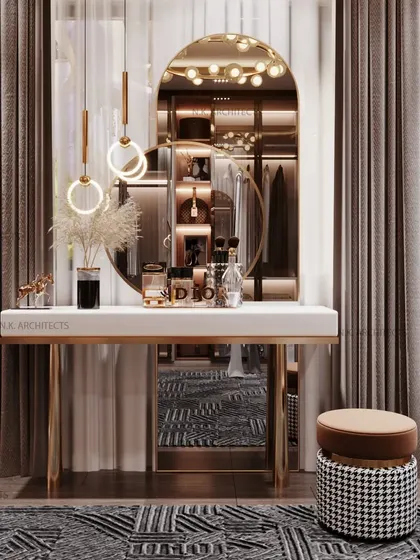 A luxury dresser setup that is both elegant and functional. The console table with gold legs, an arched mirror, and modern pendant lights create a perfect spot for getting ready.