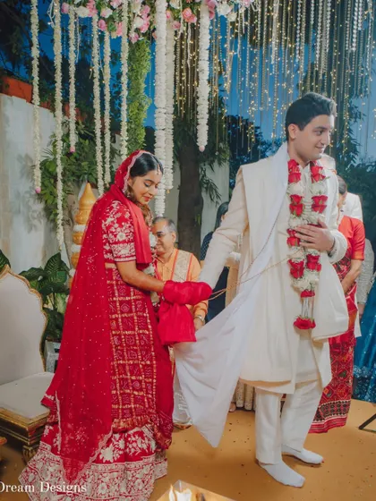 The 'saat phere' is a beautiful tradition. The decor, with its hanging floral strings and soft lighting, creates a gentle and respectful ambiance for these important rituals.